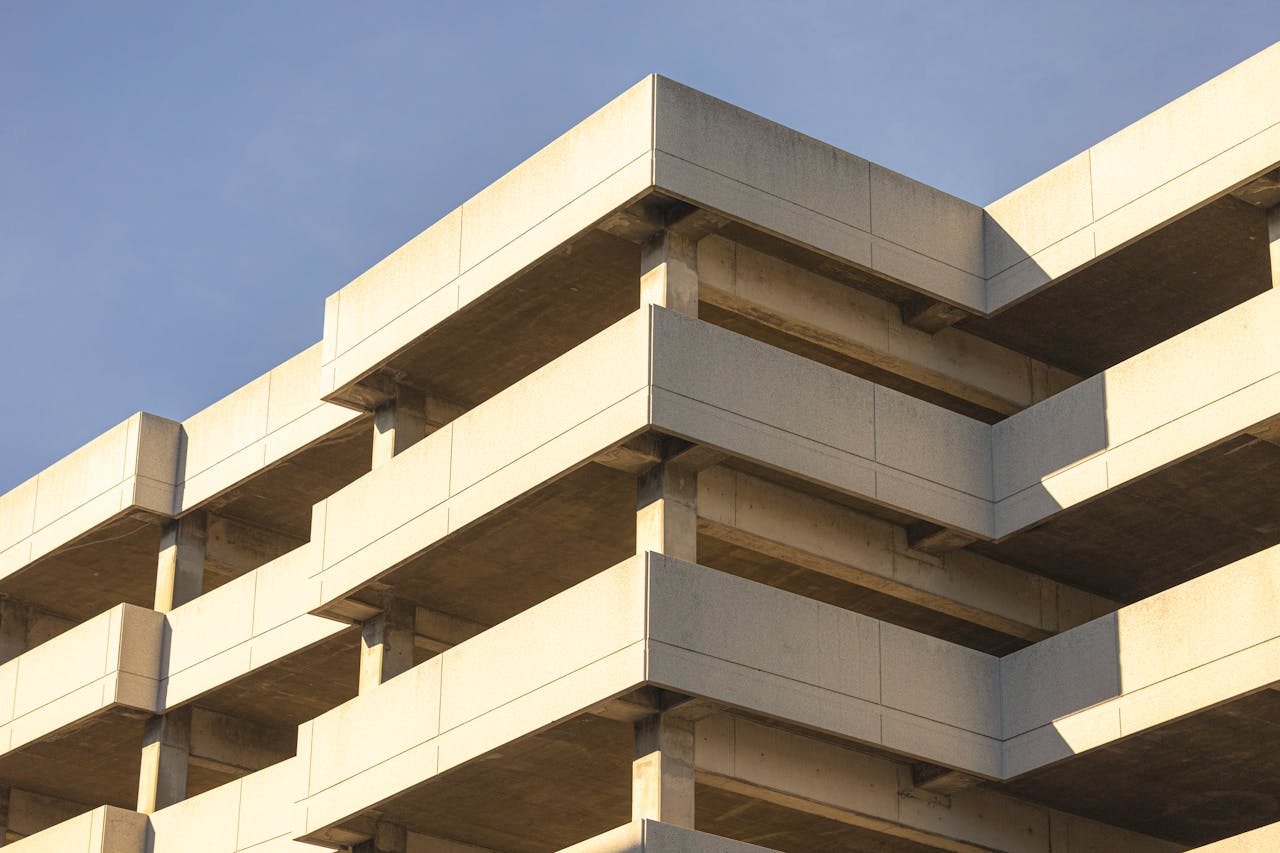 Mastering the First Impression: Your intriguing post title goes here Concrete parking structure against clear blue sky, showcasing modern architecture.